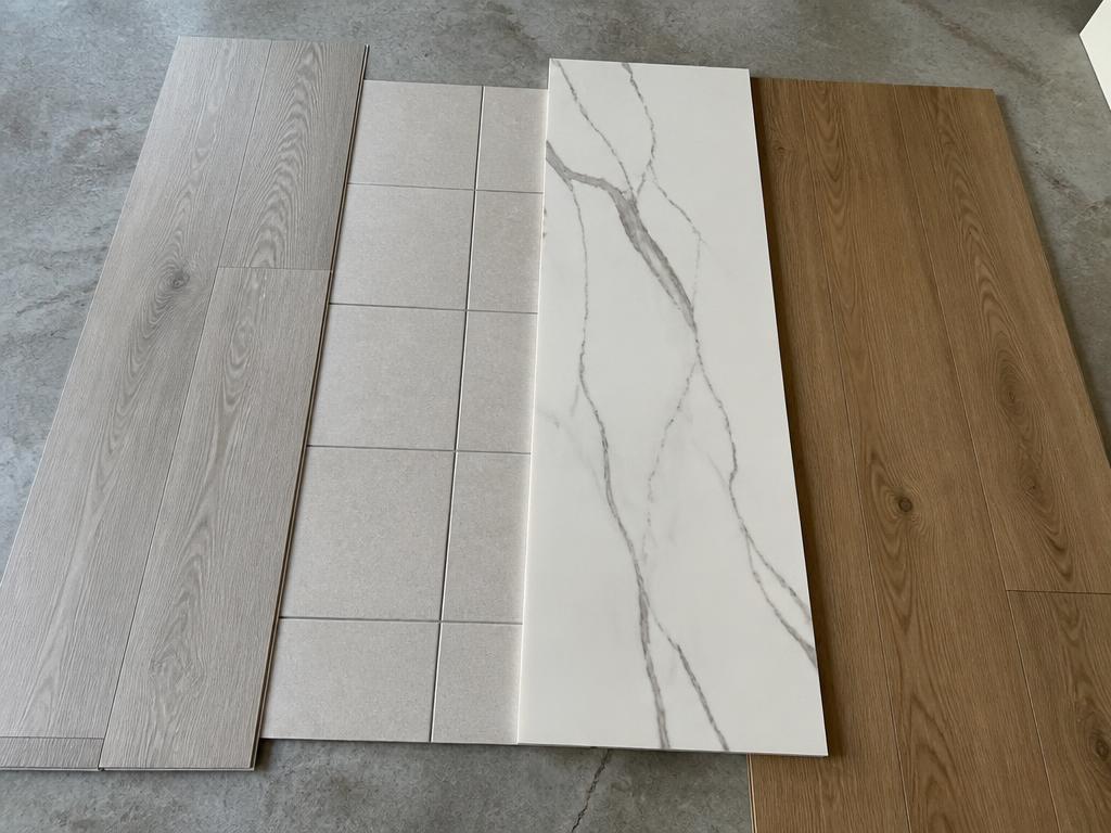 Vinyl, tile, marble and timber flooring samples side by side